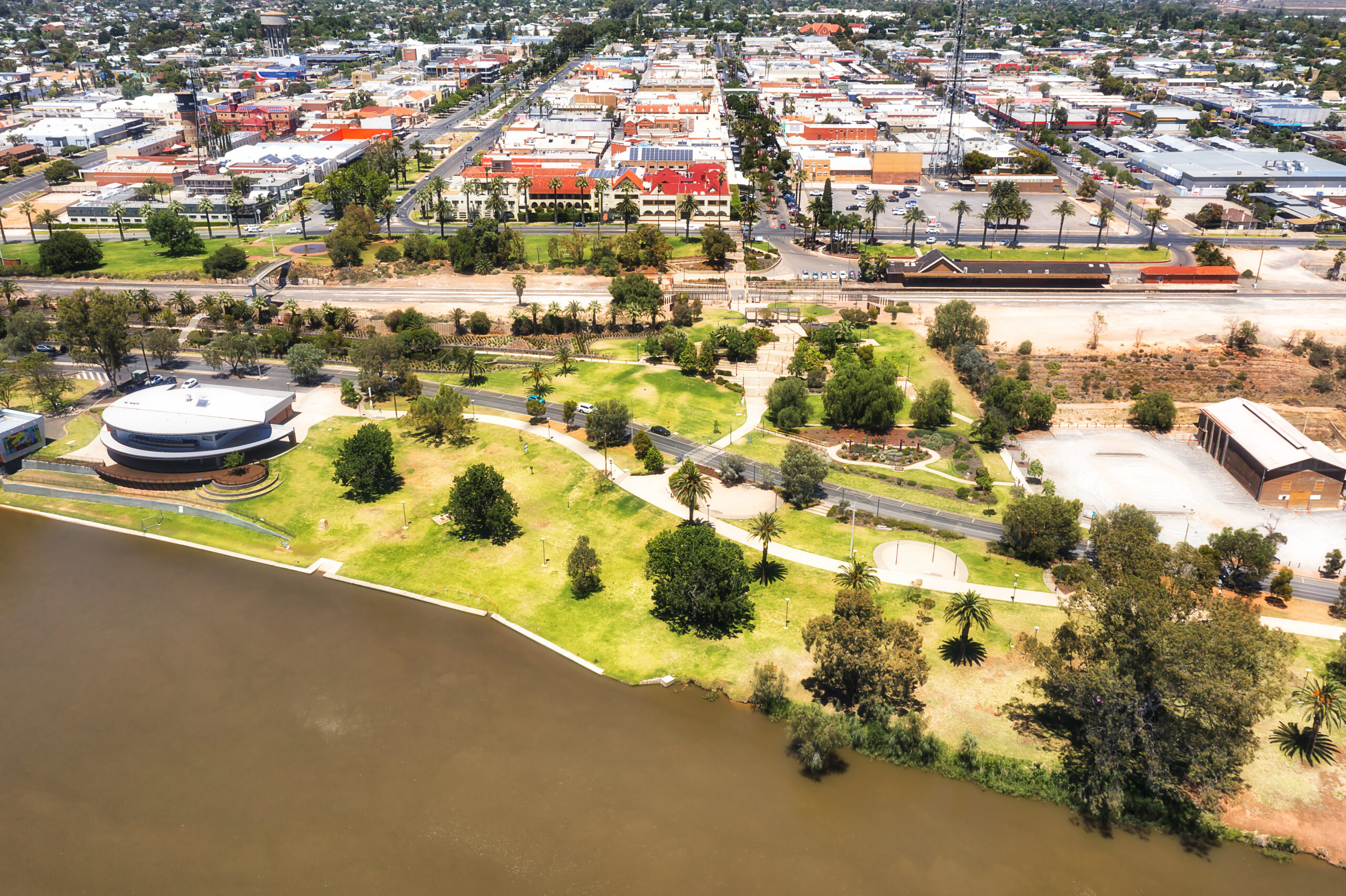 Waterfront of Mildura city on Murray river with train station and downtown - aerial cityscape.